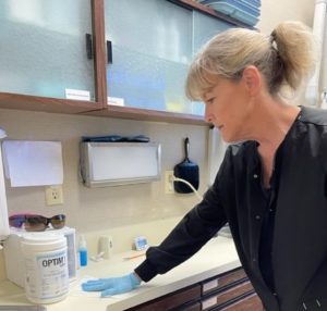 A woman preparing OPTIM-1 for a treatment