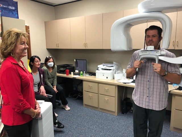 Staff watching patient use CBCT scanner