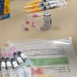 COVID-19 vaccine and syringes
